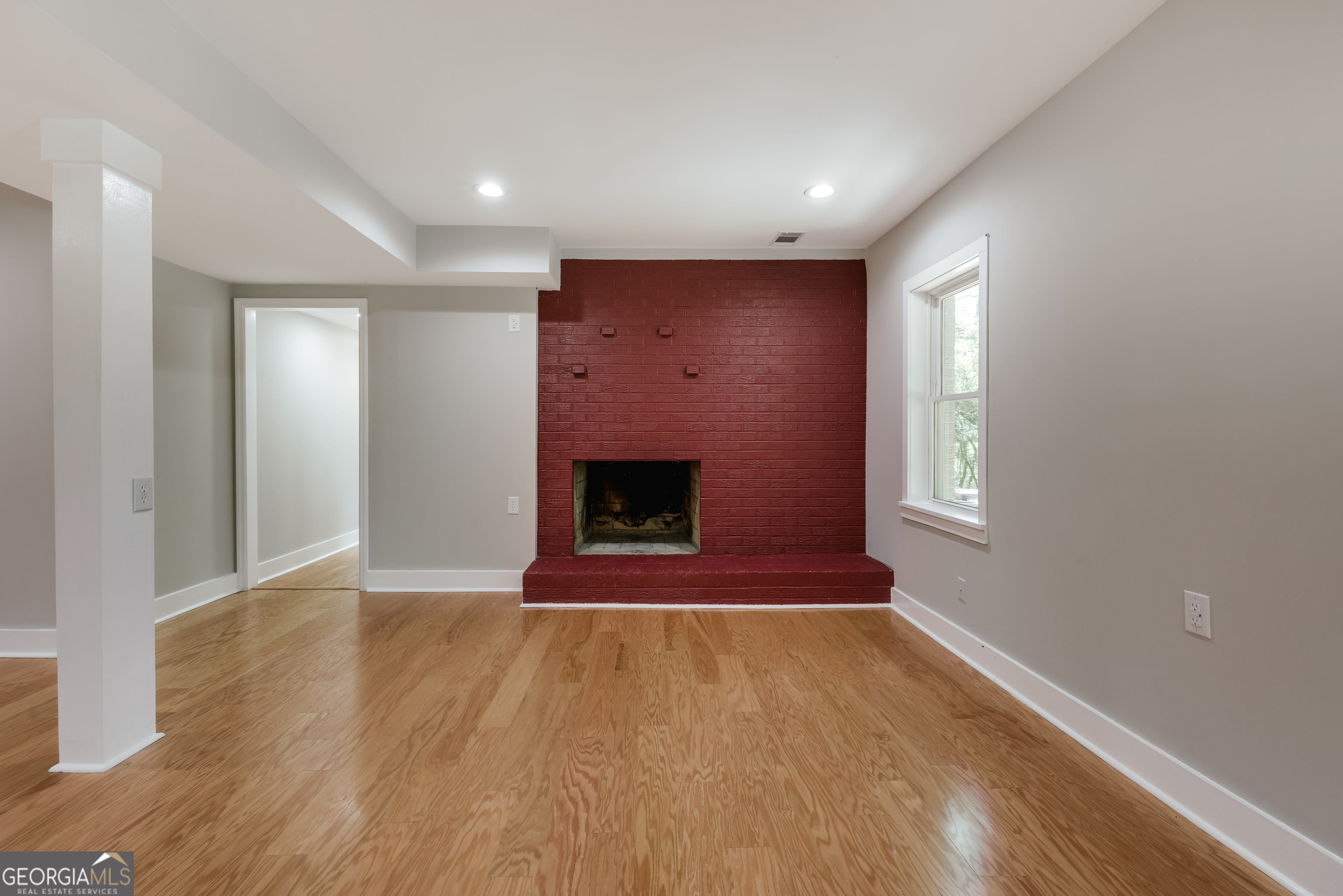 290 Fortson Drive Athens, GA 30606 - Photo 46 of 61 a view of an empty room with wooden floor fireplace and a window