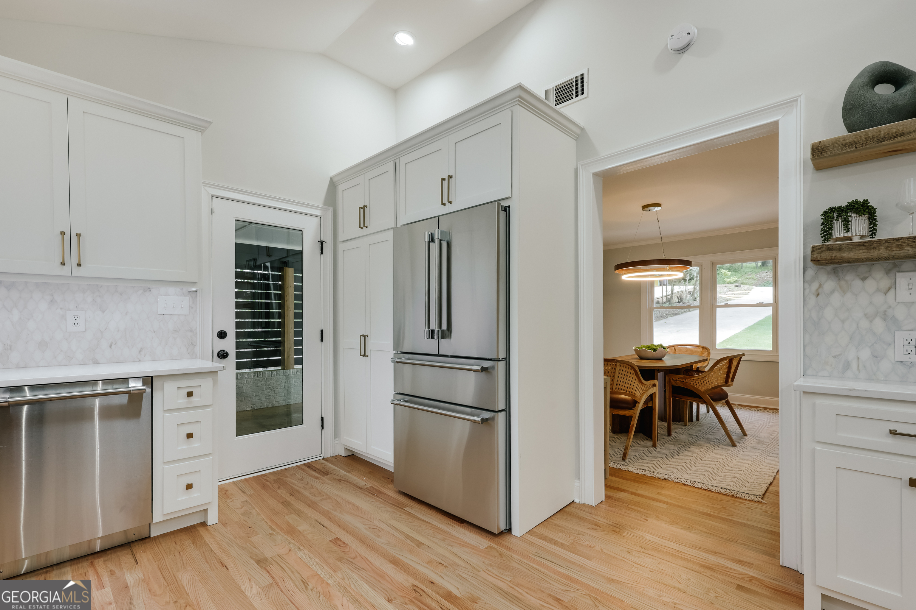 290 Fortson Drive Athens, GA 30606 - Photo 10 of 61 a kitchen with stainless steel appliances a refrigerator and wooden floor