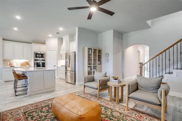 a living room with furniture and kitchen view