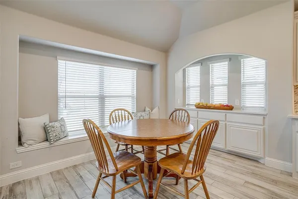 a dining room with furniture and windows