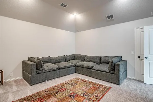 a living room with furniture and a rug