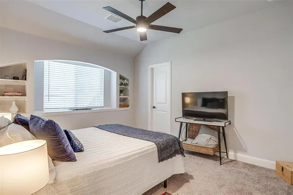 a bedroom with a bed and a tv