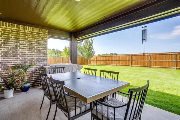 a view of a patio with table and chairs