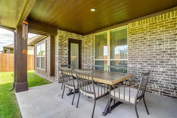 a balcony with table and chairs