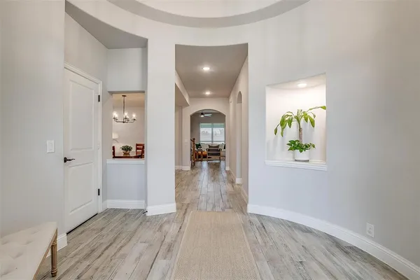 a view of a hallway view with wooden floor and staircase