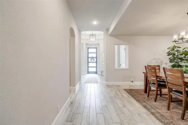 a dining room with furniture and wooden floor