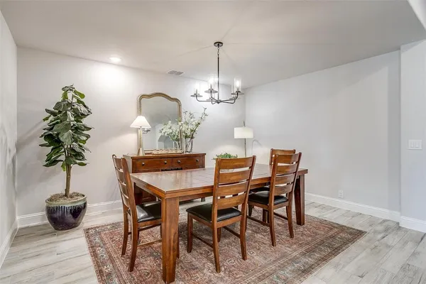 a dining room with furniture and wooden floor