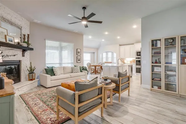 a living room with furniture a fireplace and a flat screen tv