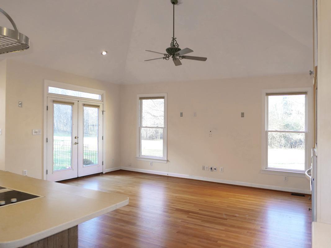 5330 Foxlair Road Chapel Hill, NC 27516 - Photo 15 of 43 a view of an empty room with wooden floor and a window