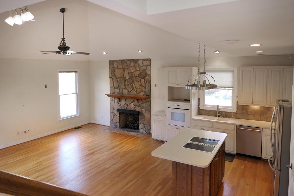 5330 Foxlair Road Chapel Hill, NC 27516 - Photo 18 of 43 a kitchen with granite countertop a stove a sink a refrigerator and a fireplace
