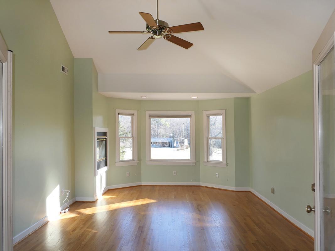 5330 Foxlair Road Chapel Hill, NC 27516 - Photo 25 of 43 a view of an empty room with window and wooden floor