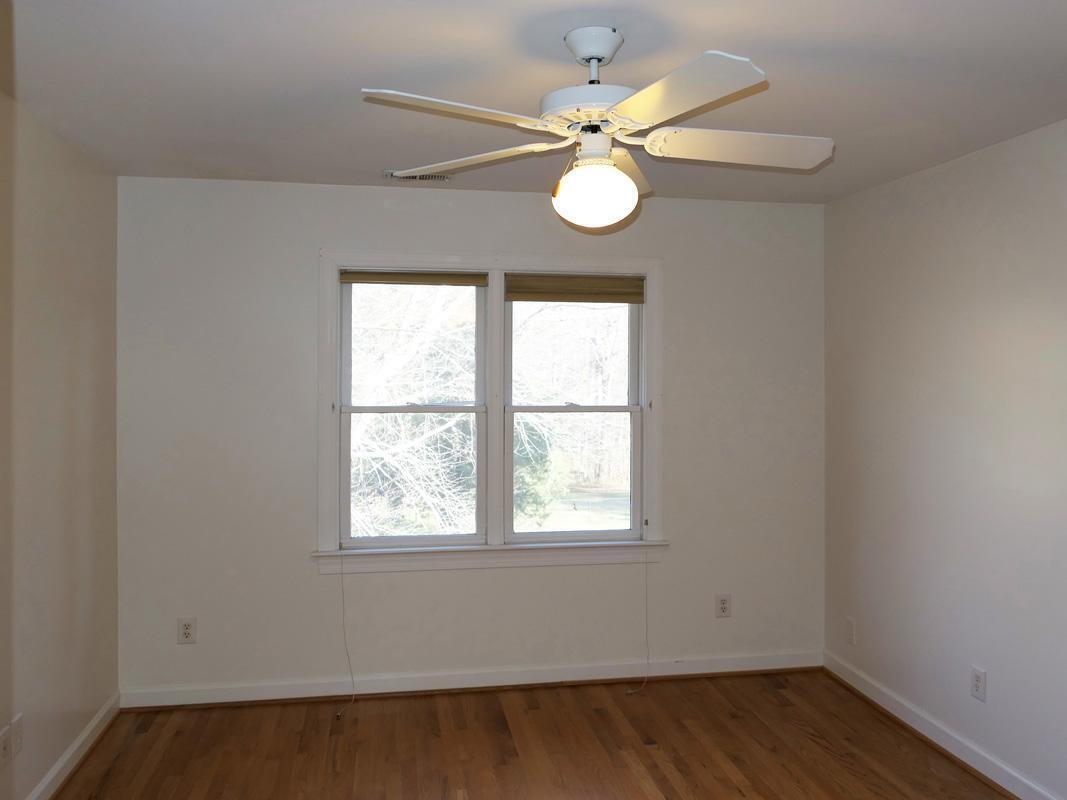 5330 Foxlair Road Chapel Hill, NC 27516 - Photo 31 of 43 an empty room with wooden floor and windows