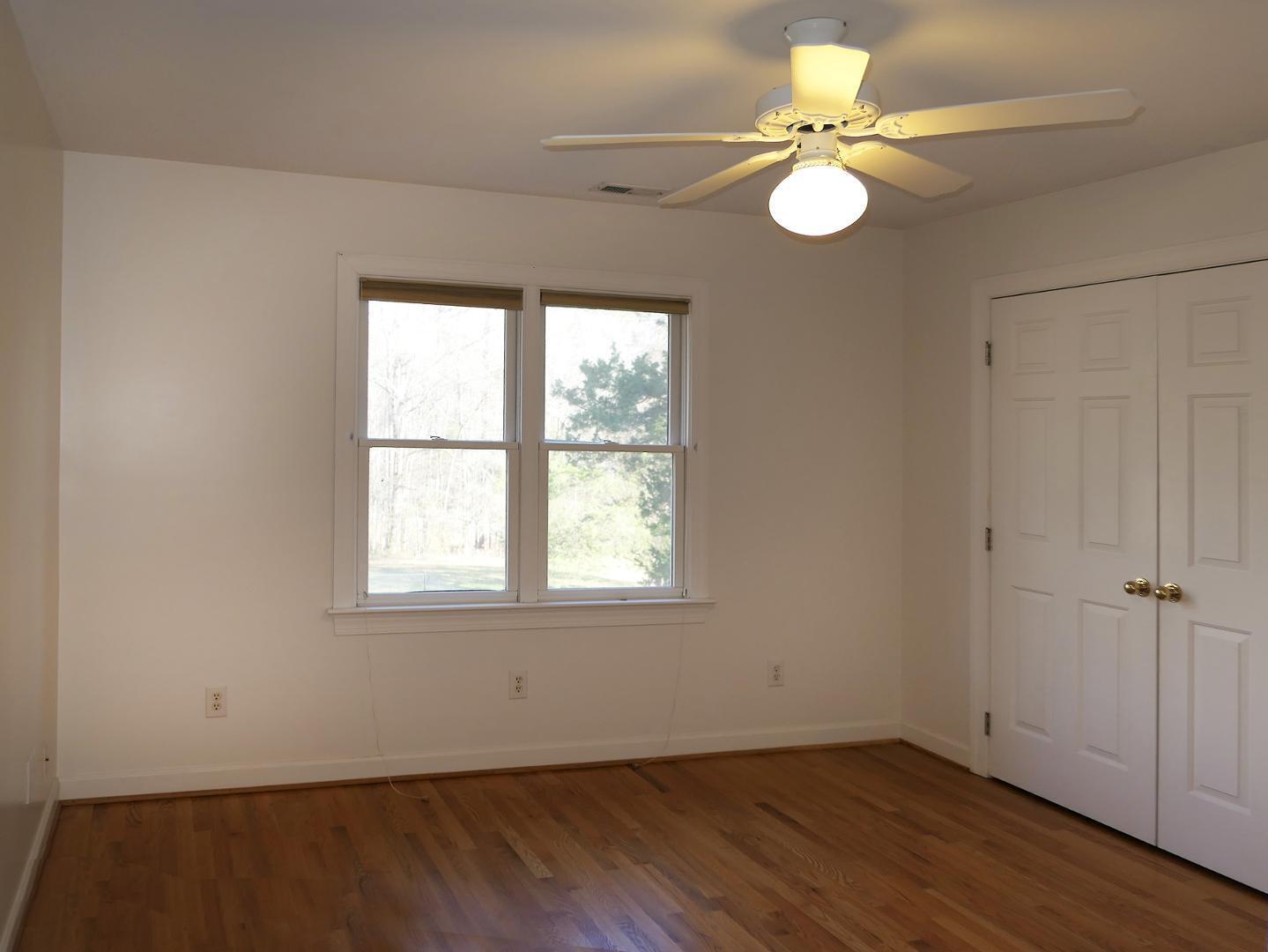 5330 Foxlair Road Chapel Hill, NC 27516 - Photo 32 of 43 an empty room with wooden floor and window