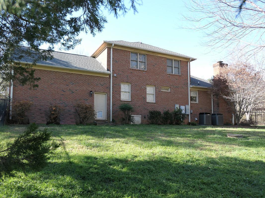5330 Foxlair Road Chapel Hill, NC 27516 - Photo 41 of 43 a view of a brick house with a big yard and large trees