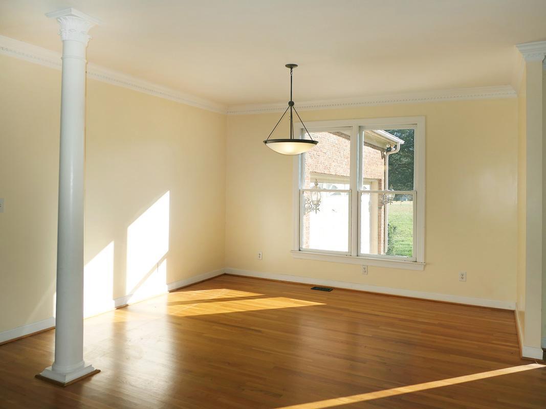5330 Foxlair Road Chapel Hill, NC 27516 - Photo 9 of 43 a view of an empty room with wooden floor and a window