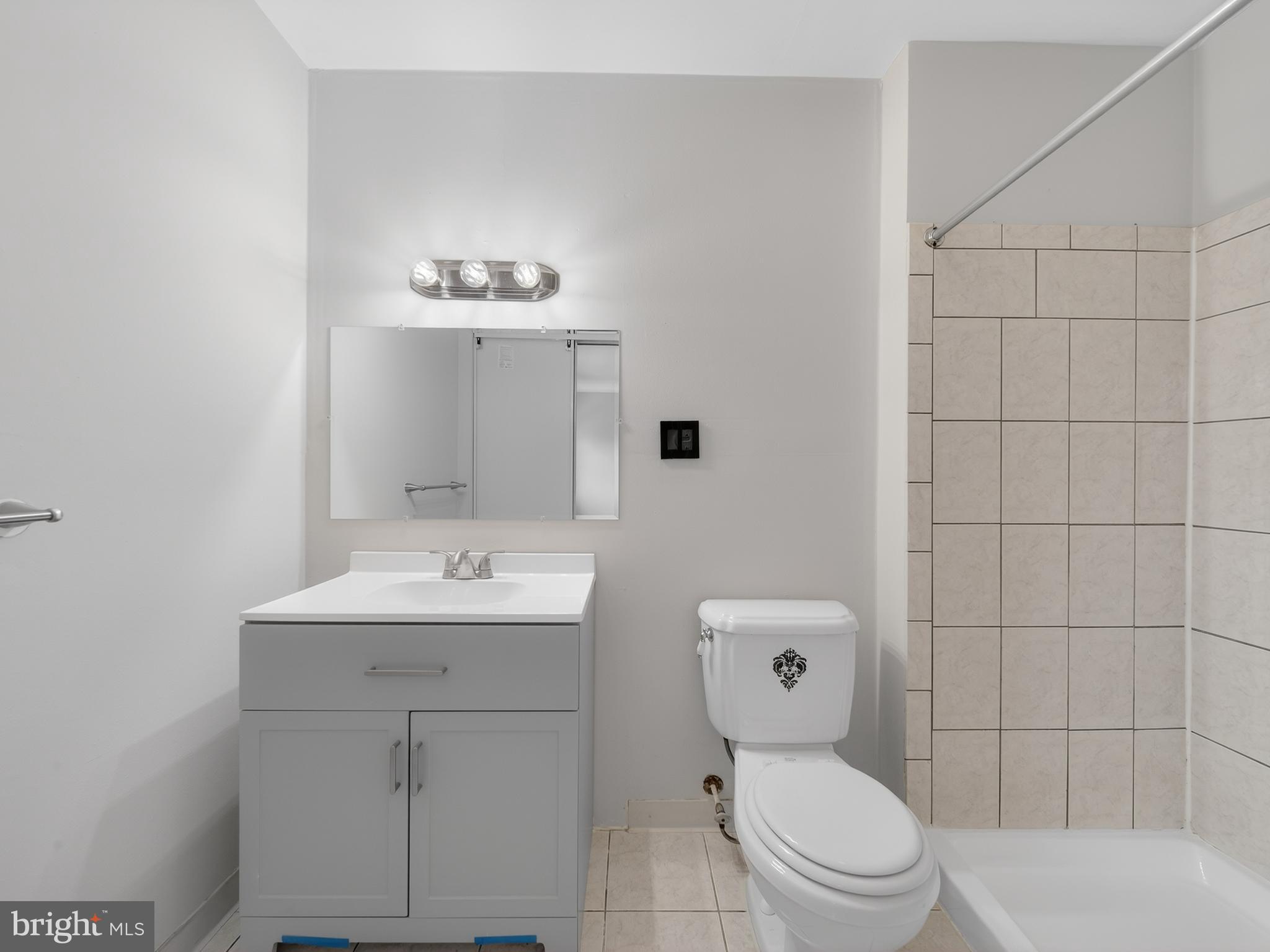 8040 Sandy Spring Road, Unit 8040 Laurel, MD 20707 - Photo 21 of 44 a bathroom with a toilet sink and mirror