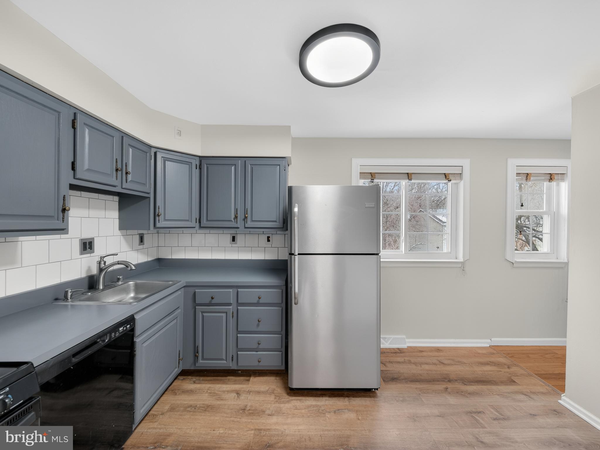 8040 Sandy Spring Road, Unit 8040 Laurel, MD 20707 - Photo 8 of 44 a kitchen with a refrigerator sink and cabinets