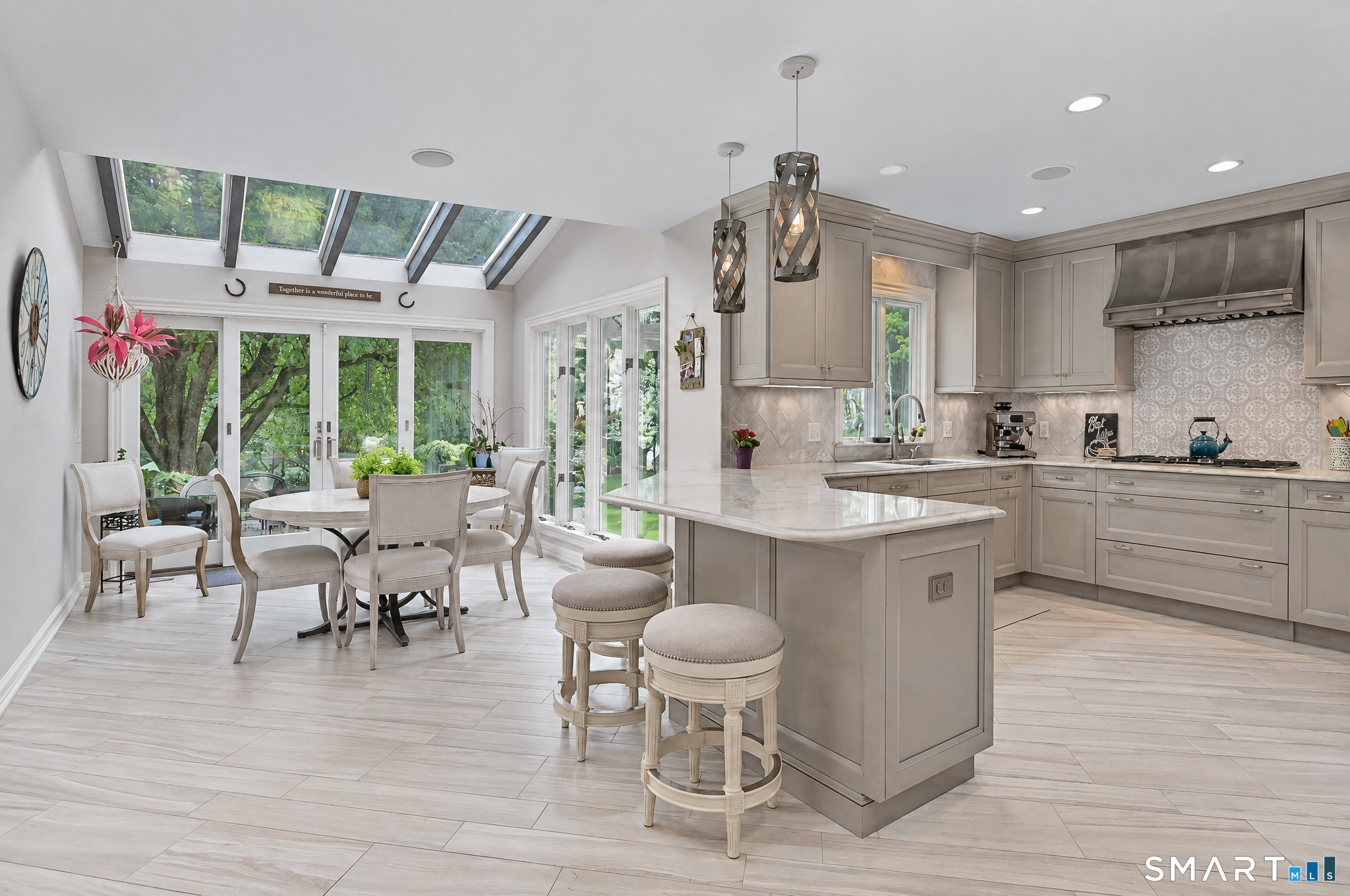 16 Winding Brook Road Newtown, CT 06470 - Photo 12 of 39 Bright eat-in kitchen featuring a large center island, skylights, walls of windows and access to the outdoor living areas.