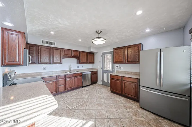an empty room with windows and ceiling fan