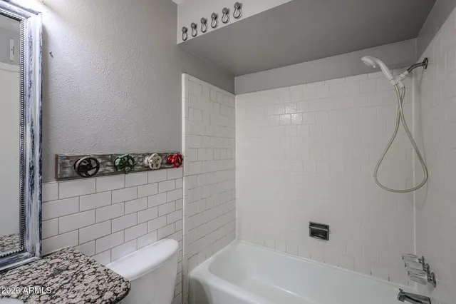 a view of an empty room with a ceiling fan