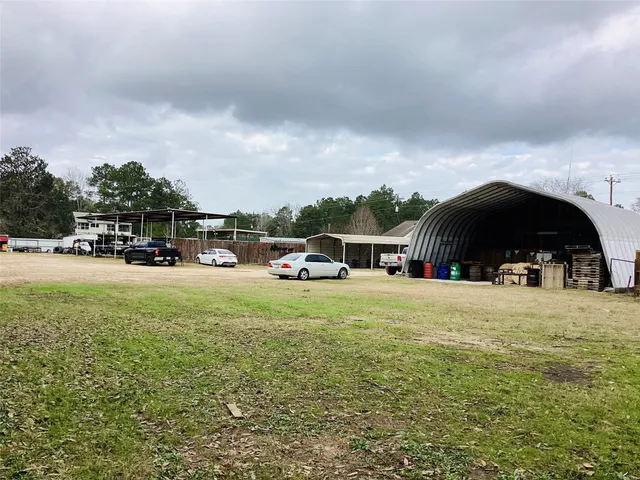 a tall yellow house with trees in front of it