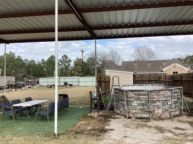 a view of a patio with a table chairs and a fire pit