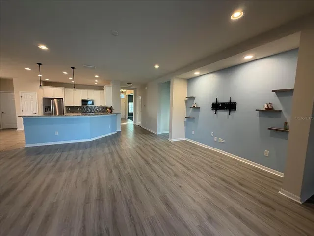 a view of a kitchen with refrigerator and microwave