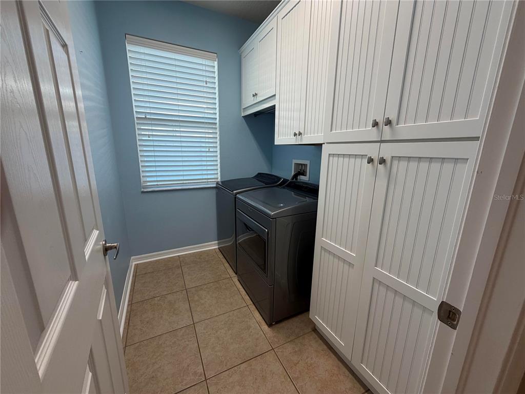 11342 77th Street East Parrish, FL 34219 - Photo 13 of 31 a view of a kitchen with refrigerator and microwave