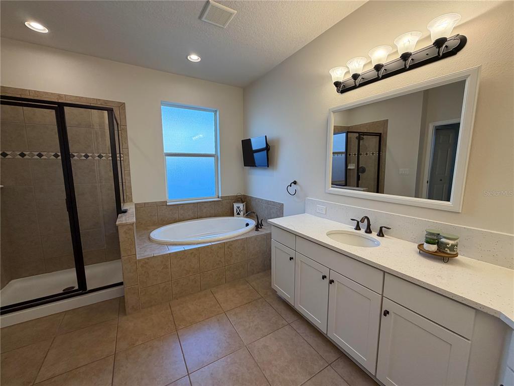 11342 77th Street East Parrish, FL 34219 - Photo 16 of 31 a bathroom with a tub sink and mirror