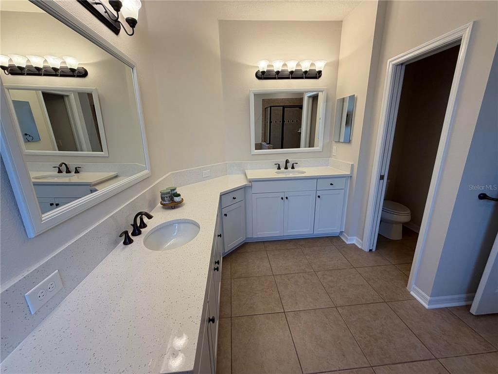 11342 77th Street East Parrish, FL 34219 - Photo 17 of 31 a bathroom with a tub sink and mirror