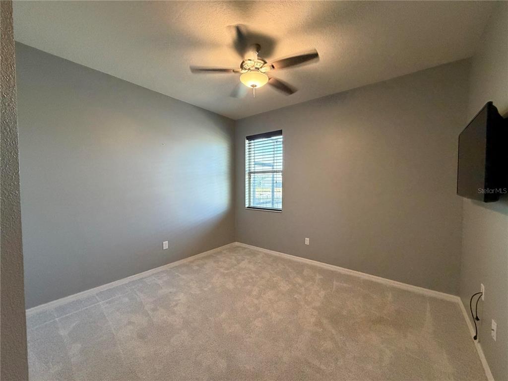 11342 77th Street East Parrish, FL 34219 - Photo 18 of 31 a view of an empty room with a ceiling fan and window
