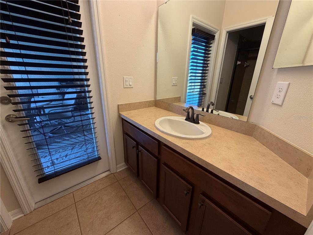 11342 77th Street East Parrish, FL 34219 - Photo 19 of 31 a bathroom with a sink and a mirror