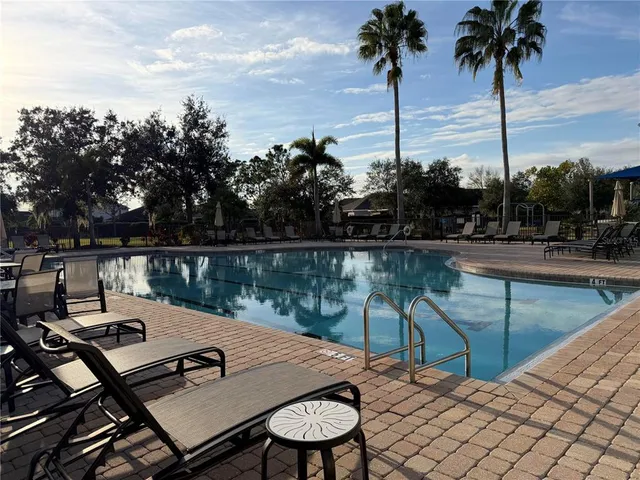 a view of a lake with chairs