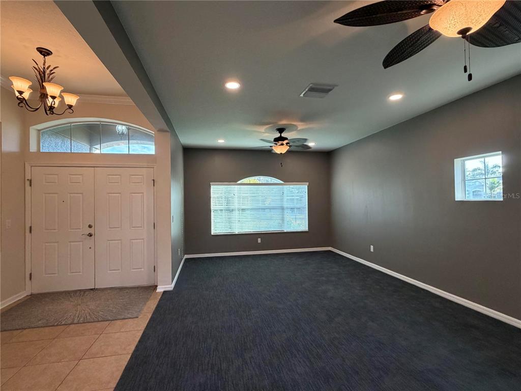 11342 77th Street East Parrish, FL 34219 - Photo 3 of 31 wooden floor in an empty room with a window