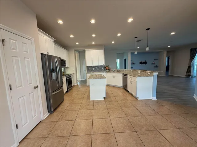 a kitchen with stainless steel appliances granite countertop a sink a counter top space and cabinets