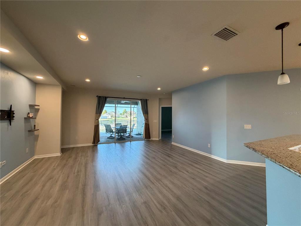 11342 77th Street East Parrish, FL 34219 - Photo 9 of 31 a view of empty room with wooden floor and fan