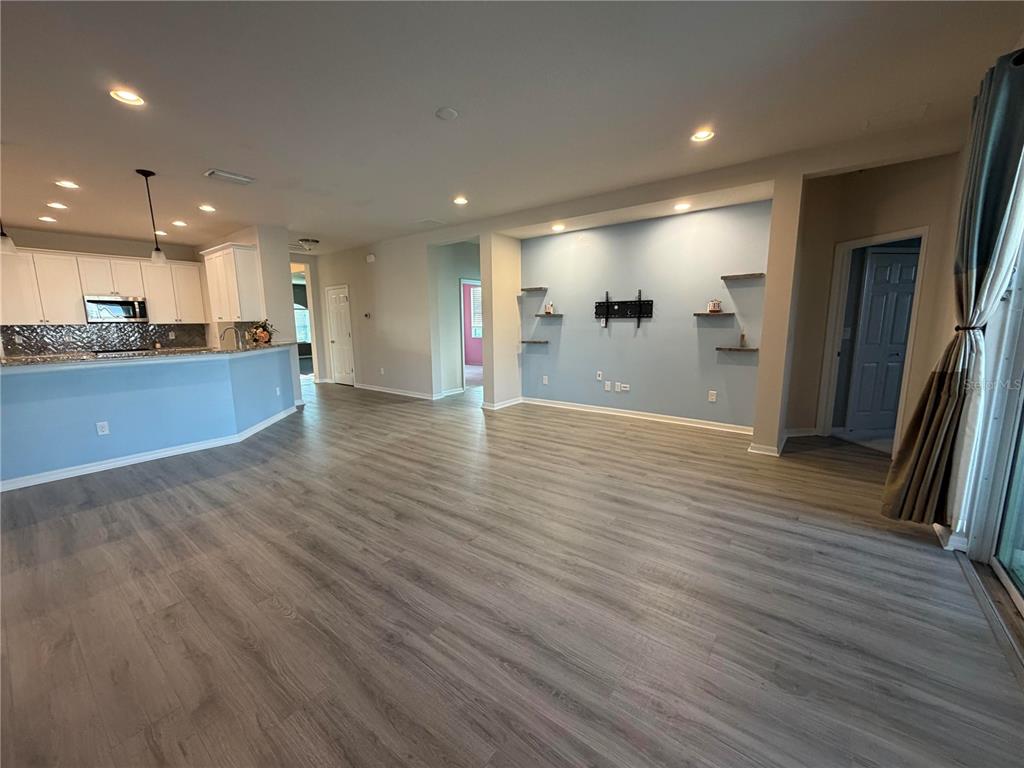 11342 77th Street East Parrish, FL 34219 - Photo 10 of 31 a view of a big room with wooden floor and windows
