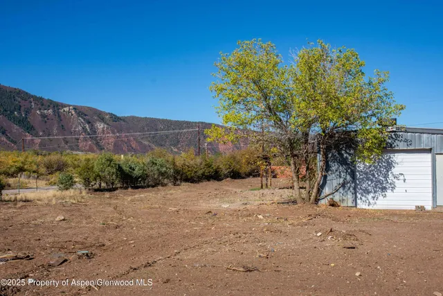 a view of a road with a house in the background