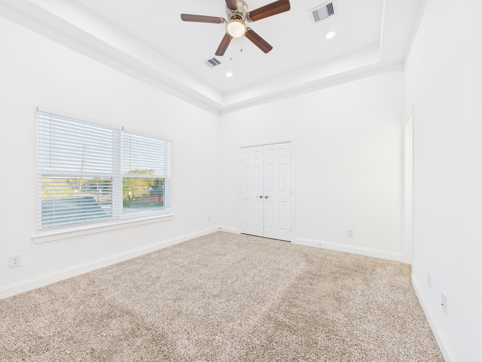 4619 Stassen Street, Unit B Houston, TX 77051 - Photo 13 of 29 an empty room with windows and fan