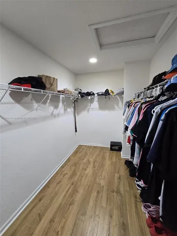 a bathroom with a tub a sink and a mirror