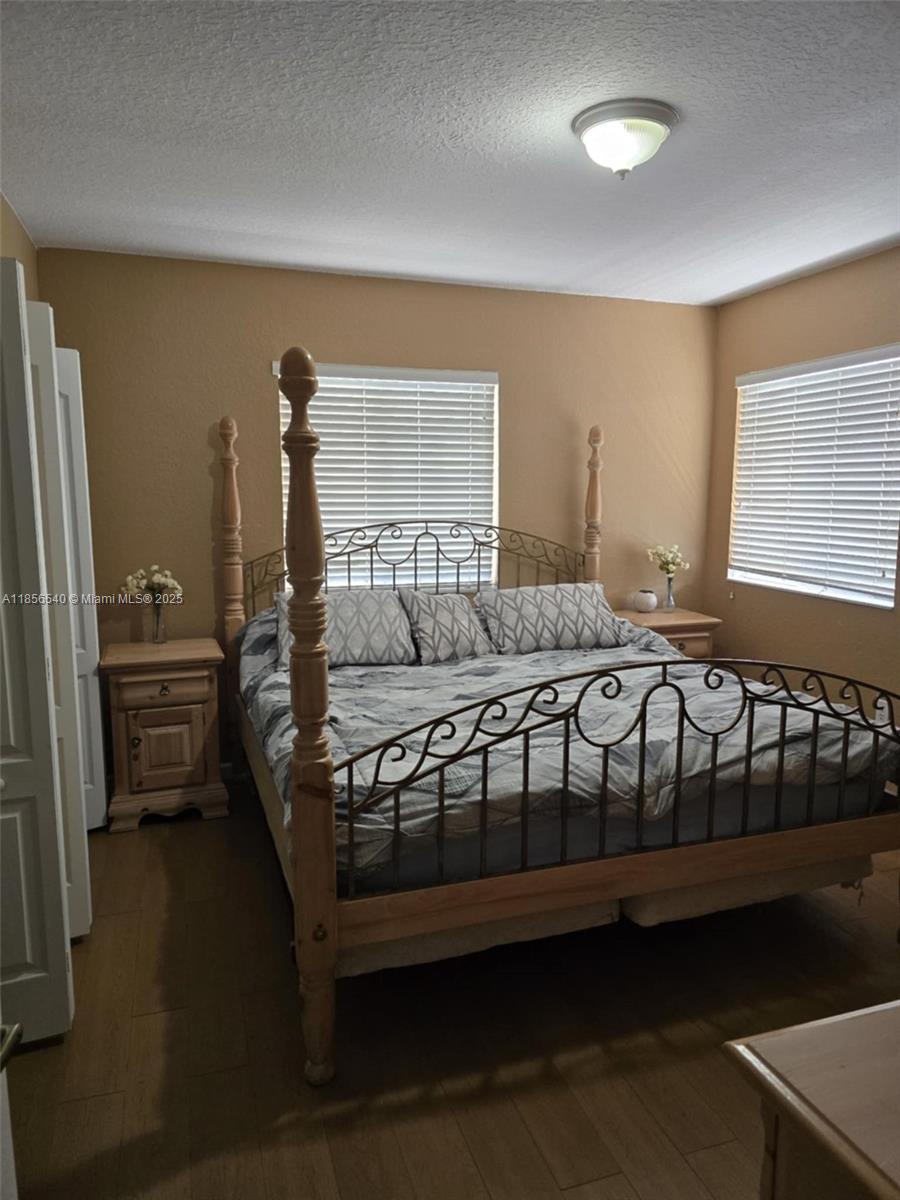13994 Southwest 278th Street Homestead, FL 33032 - Photo 14 of 19 a bedroom with a bed next to a window
