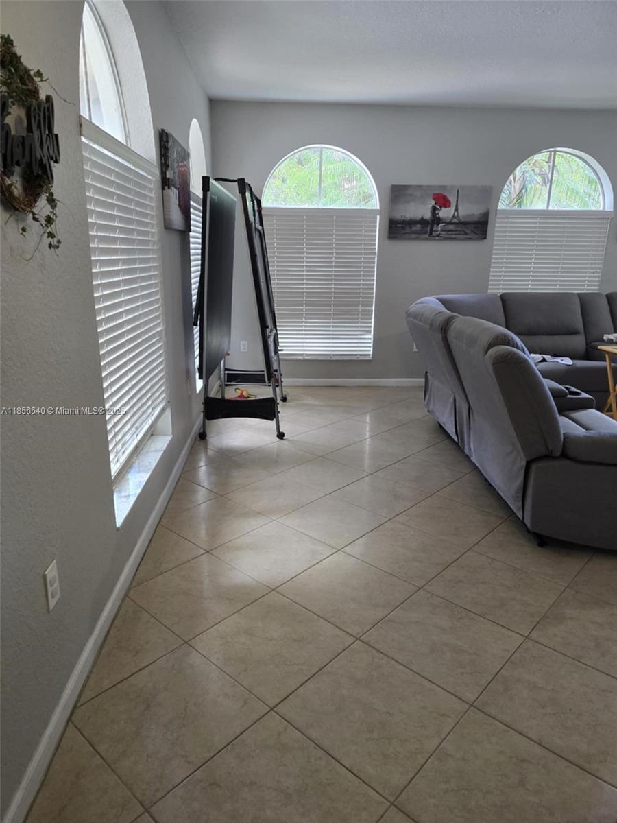13994 Southwest 278th Street Homestead, FL 33032 - Photo 5 of 19 a living room with furniture and a window