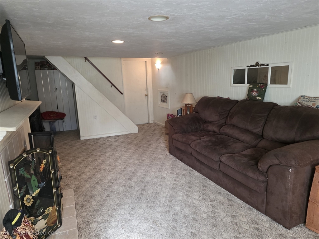 304 High Street Randolph, MA 02368 - Photo 27 of 35 a living room with furniture and a flat screen tv