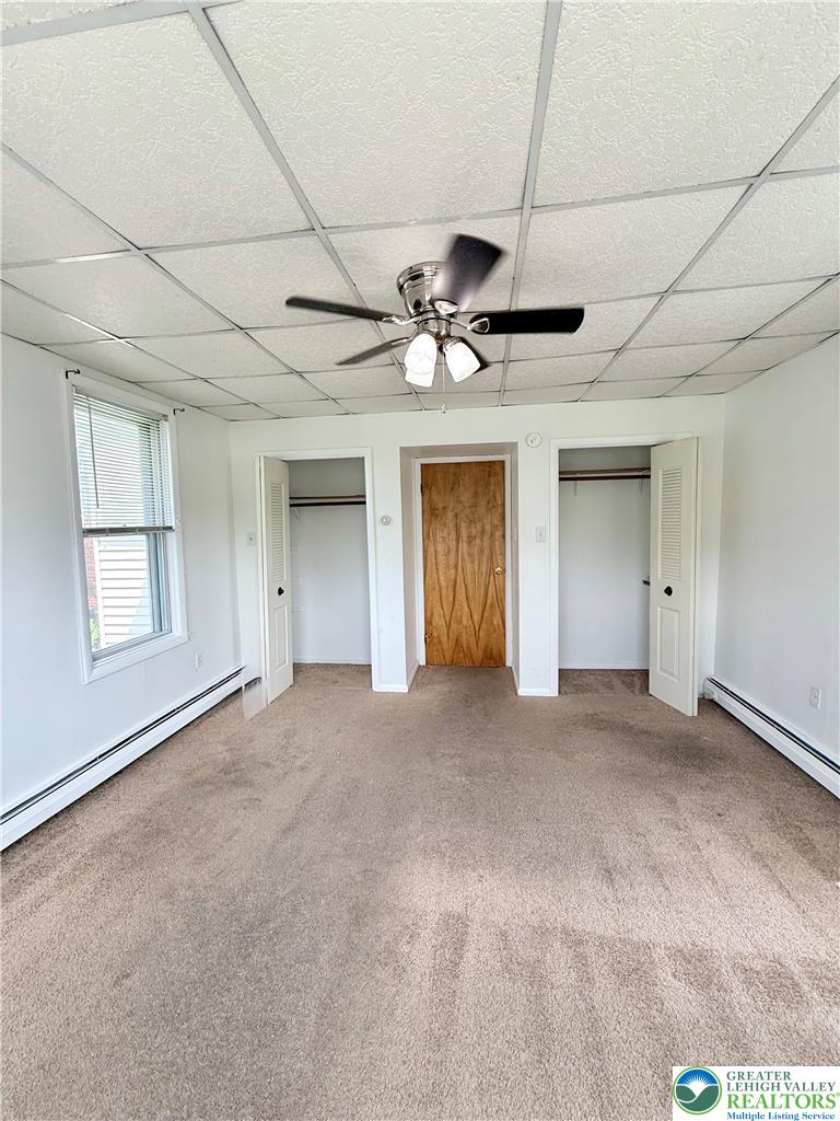 5540 Main Street Whitehall, PA 18052 - Photo 37 of 53 A comfortable bedroom with soft carpeting and functional ceiling fan offers a peaceful retreat.