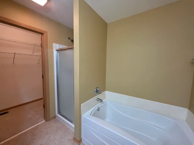 a bathroom with a tub and shower