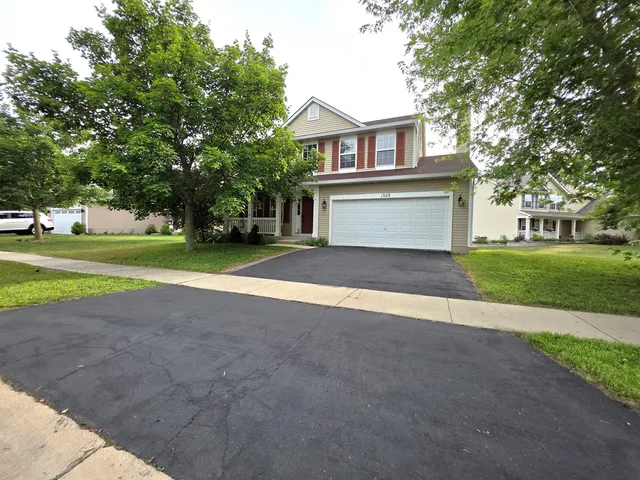 a front view of a house with a yard and garage