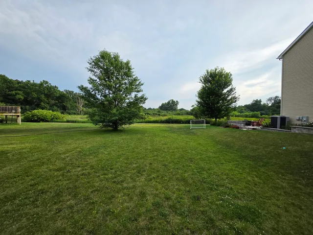 a view of grassy field with grass and trees