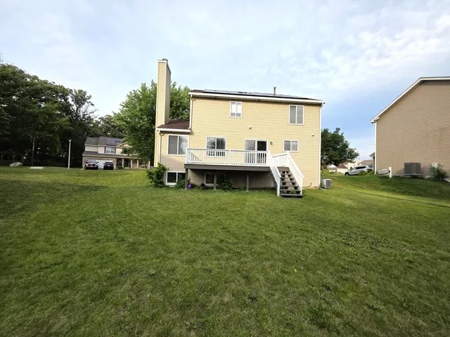 a view of a house with a backyard