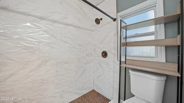 a bathroom with a shower and a sink