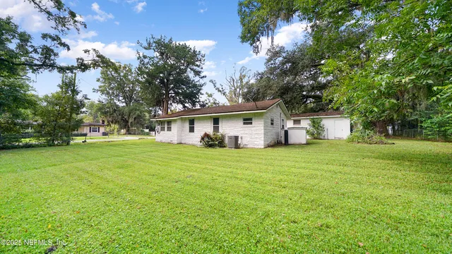 a front view of house with a garden